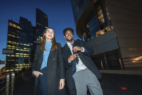 Diverse businesspeople enjoying a joyful moment together while standing on a promenade with