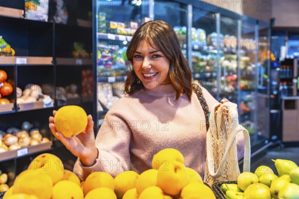 Young woman shopping for organic produce in a grocery store, holding a fresh yellow fruit and