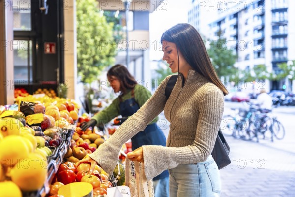 Smiling woman choosing fresh organic fruit and vegetables at an outdoor market stall, embracing a