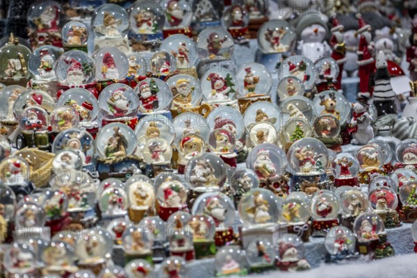 Christmas market, sales stand for decorative items, snow globes with Christmas motifs, North