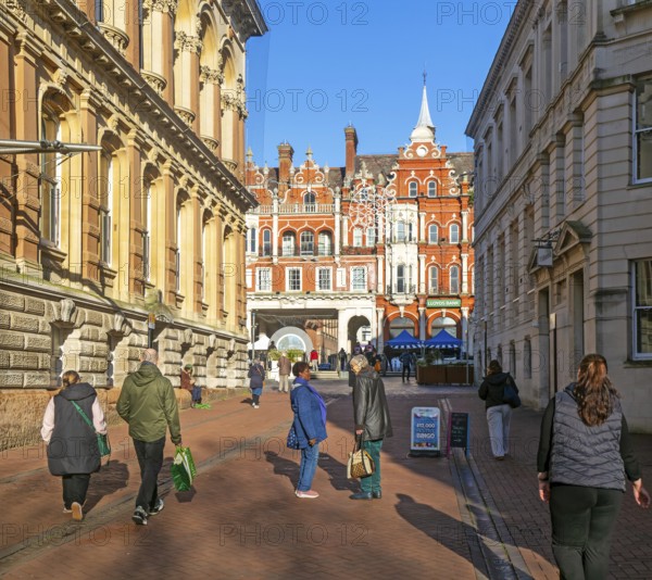 People walking chatting in pedestrianised area, Princes street, town centre of Ipswich, Suffolk,