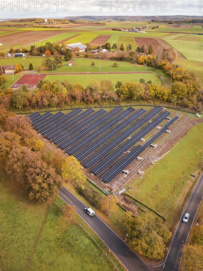 Solar systems in the middle of an autumnal landscape with a rural road, construction PV