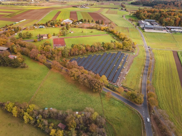 Extensive view of solar systems between fields and autumn trees, Bau PV Freifaechenanlage, Weil der