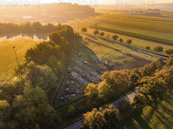 Wide landscape at sunrise, enlivened by autumn colors and soft light, PV Freifaechenanlage