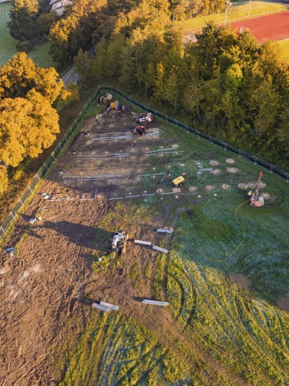 Construction site with machines and construction grids in a natural environment, Bau PV