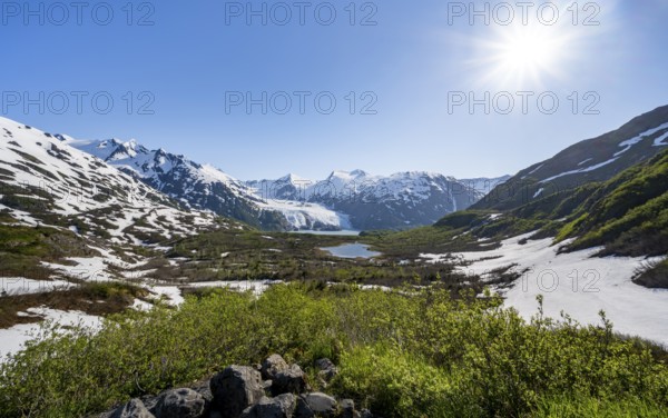 View from Portage Pass of Divide Lake, snowy mountain peaks and glaciers Portage Glacier, Portage