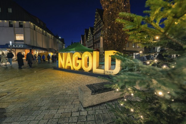Festive scene at night with illuminated Nagold lettering and people, Christmas market 2025, Nagold,