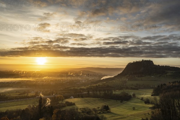 Sunrise with the Hohentwiel Hegau volcano, plumes of smoke from the burnt down historic bushel hall