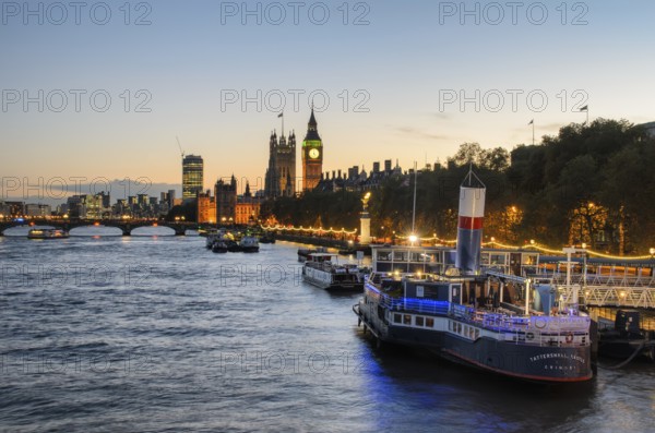 View over the Thames at golden hour with the Palace of Westminster and Elizabeth Tower, Big Ben, a