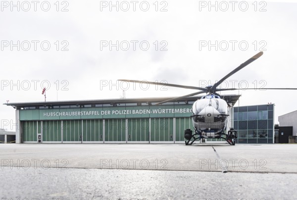 Helicopter from the Baden-WÃ¼rttemberg Police team in front of the hangar at the airport. Airbus