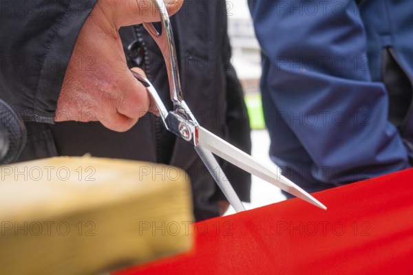 Close-up of scissors cutting a red ribbon at an opening ceremony, Sindelfingen, Böblingen district,