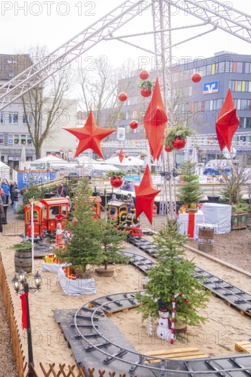 A festively decorated Christmas market with trees, trains and big red stars, Sindelfingen,