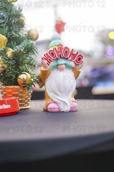 Happy dwarf holding 'Ho Ho Ho' sign against Christmas background, Sindelfingen, Böblingen district,