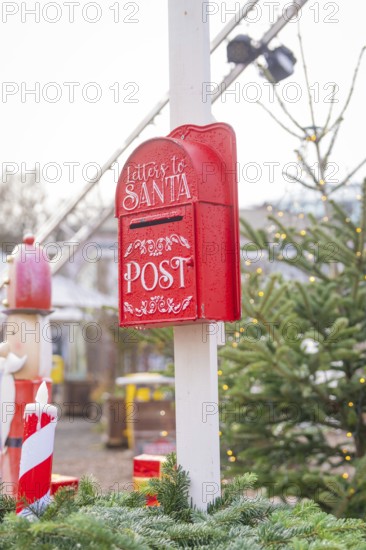 Red mailbox for Santa letters next to Christmas tree at Christmas market, Sindelfingen, Böblingen