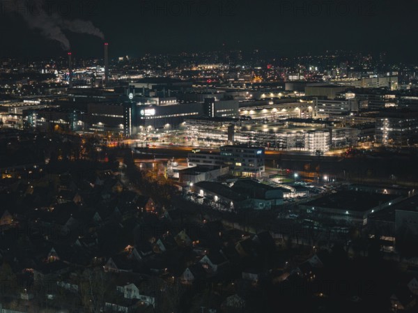 Industrial nocturnal cityscape with glowing buildings and factories, Sindelfingen, Böblingen