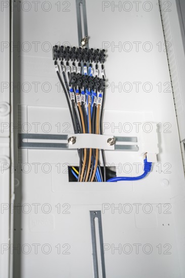 Close-up of a distribution box with several colored cables and connectors, electrician, new