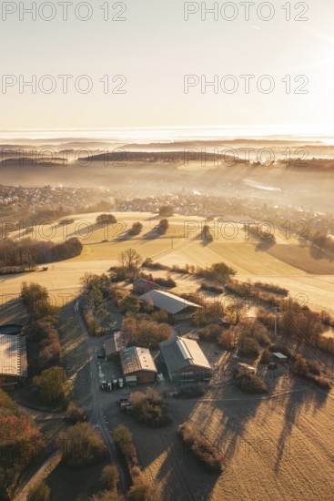Fields and farm in a slightly foggy, hilly landscape under morning light, Gechingen, Hecken and
