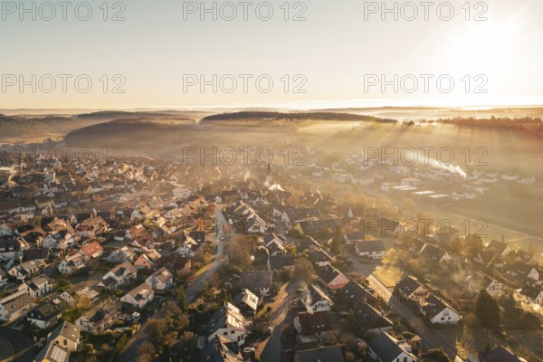 Sunrise over a village bathed in golden twilight shades, Gechingen, Hecken and GÃ¤u region, Calw