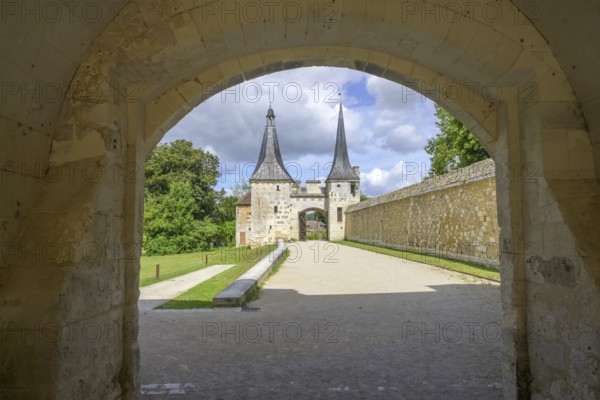 View through archway to the double tower with entrance gate at the Abbey of, Le Bec-Hellouin, Eure,