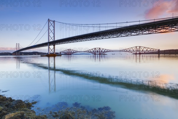 View of the Forth Road Bridge and the red Forth Bridge railway bridge at the FÃ­rth of Forth sea