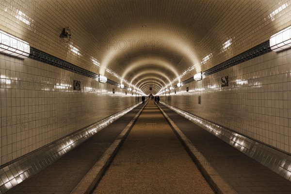 Pedestrians in the historic tunnel tube, Old Elbe Tunnel, symmetrically illuminated, tiled, Sankt