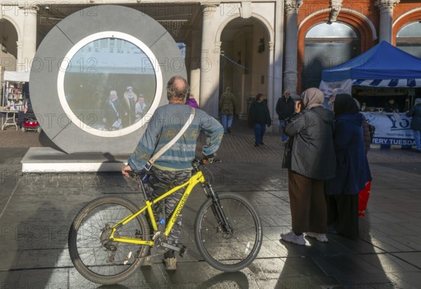 People on the Cornhill in the town centre view the first ever UK Portal in Ipswich, Suffolk,
