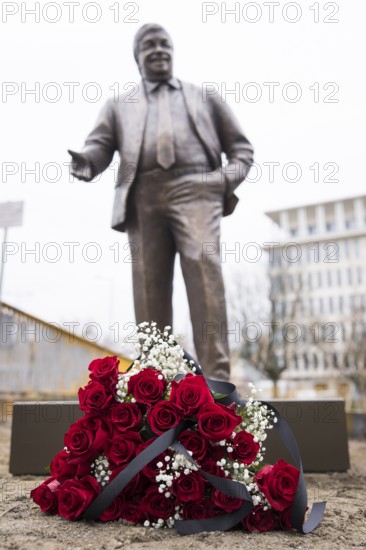 Red roses with a mourning ribbon lie in front of the Walter LÃ¼bcke memorial during the