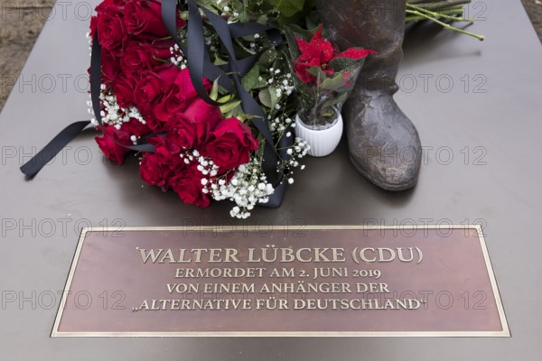 Red roses with a mourning ribbon lie on the Walter LÃ¼bcke memorial during the erection of Walter