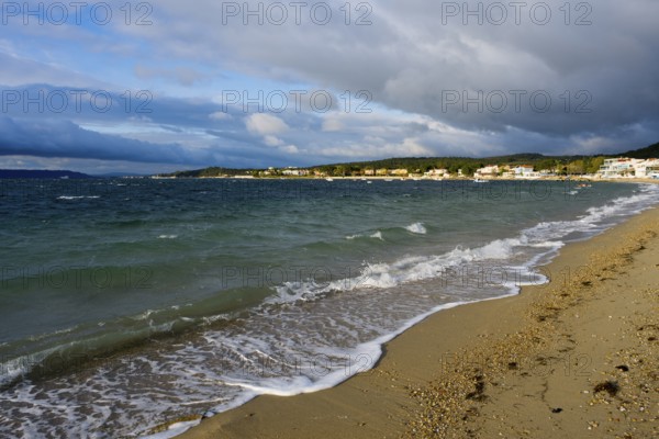 Beach with waves and a cloudy sky up to the horizon, beach near GÃ¼zelyali, GÃ¼zelyalÄ±,