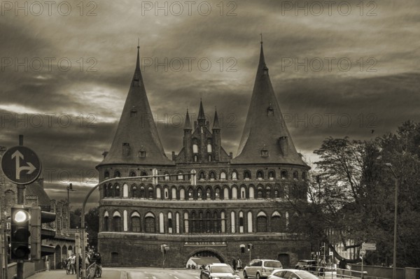Holstentor, historic city gate from 1478, in the evening, sepia, Holstentorplatz, Hanseatic City of