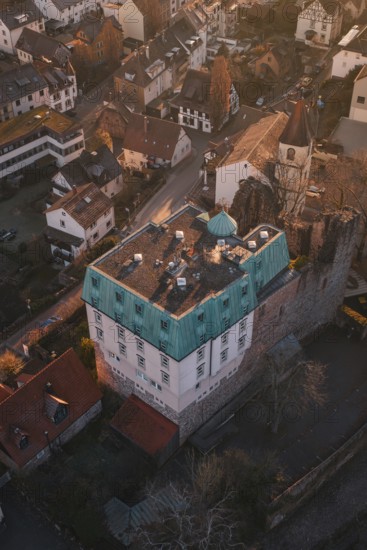 Old building with copper roof in a small village surrounded by autumn trees, Dillweisenstein,