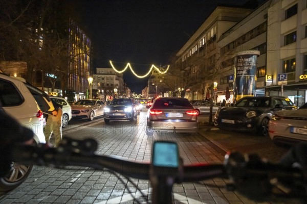 Cycling in the city, in the dark, in the evening, inner-city road, bicycle road, two-wheeler