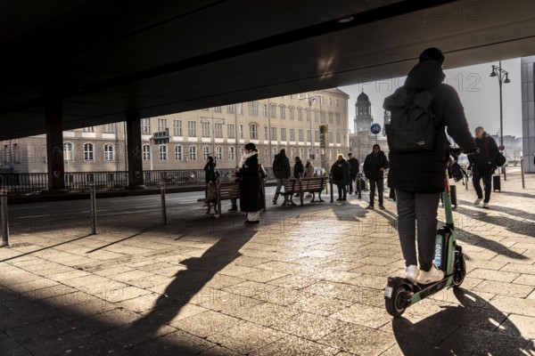 Passers-by on a sidewalk on GrunerstraÃŸe, near Alexander Platz, bus stop, in Berlin, shade, low