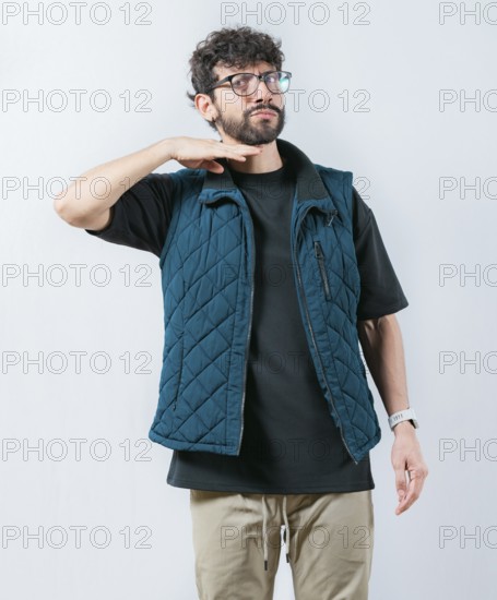 Man threatening with his finger to his throat, isolated. Person with a violent look threatening the