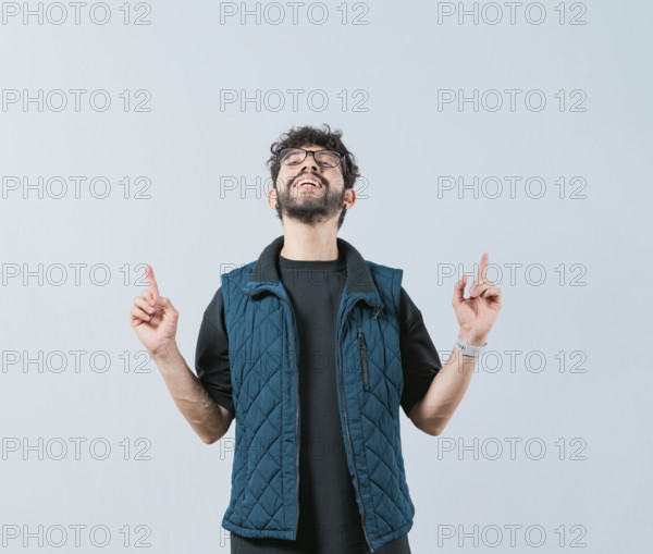Handsome man in glasses pointing an advertising up isolated. Young man pointing blank space up and