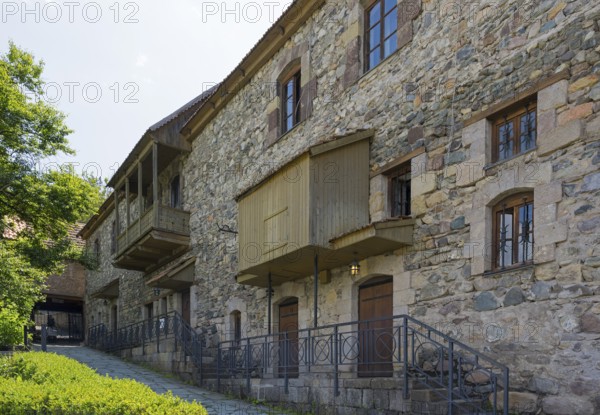 Stone building with many windows and historic charm, surrounded by nature, Old Town, Sharambeyan