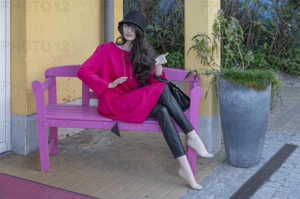 Seated mannequin fashionably dressed in front of a fashion shop, Ahrenshoop, DarÃŸ,