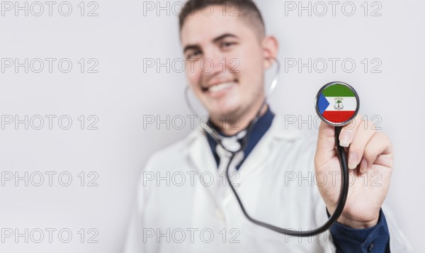 Doctor showing stethoscope with Equatorial Guinea flag. Equatorial Guinea national healthcare