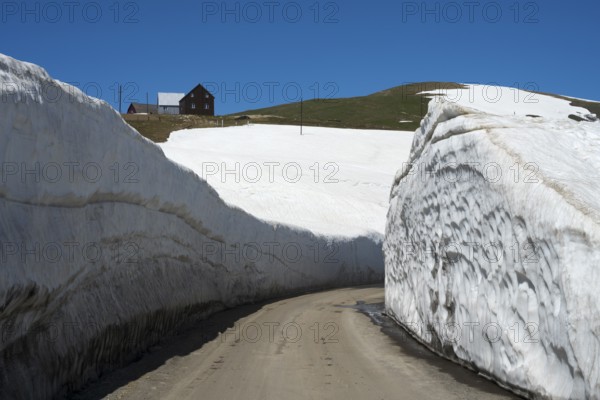 A narrow path through high snow walls in a wintry mountain landscape, Goderdzi Pass, Ajara region,