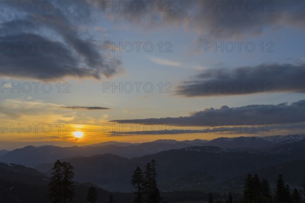 A romantic sunset over mountains with colorful sky and clouds, view from Goderdzi Pass, Ajara