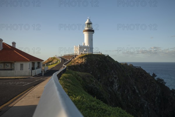 Byron Bay lighthouse on the cape with blue skies and good weather. View from the way to Cape Byron