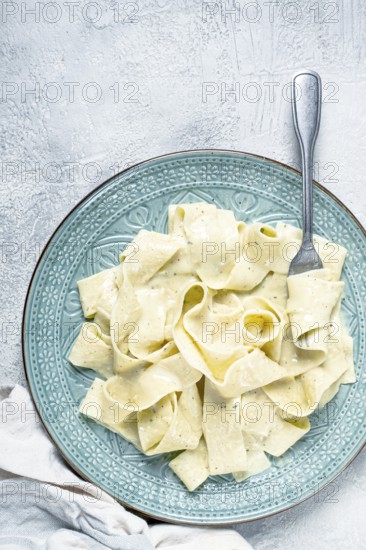 Pasta papardelle in creamy garlic sauce, traditional Italian cuisine, pasta carbonara, homemade, no