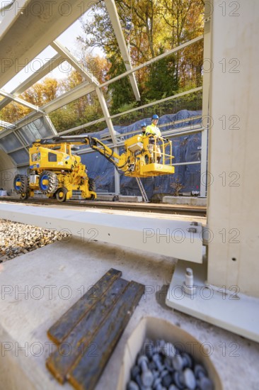 Interior view of a construction site with yellow machines and a metal frame, Hermann Hesse Railway