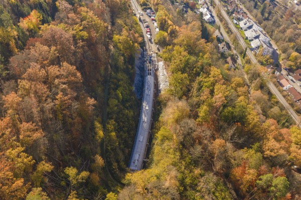 Bird's-eye view of a tunnel construction project integrated into an urban and autumnal forest