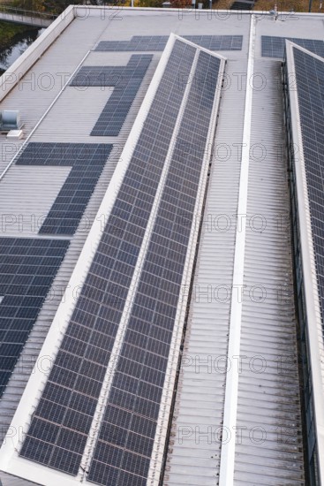Close-up of a roof with two rows of solar cells, including some technical details, PV on Walther
