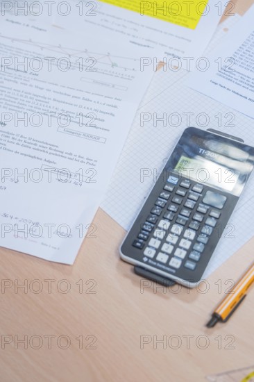 A calculator is lying on a table with mathematical documents, Jugend Forschungszentrum Nagold, Calw