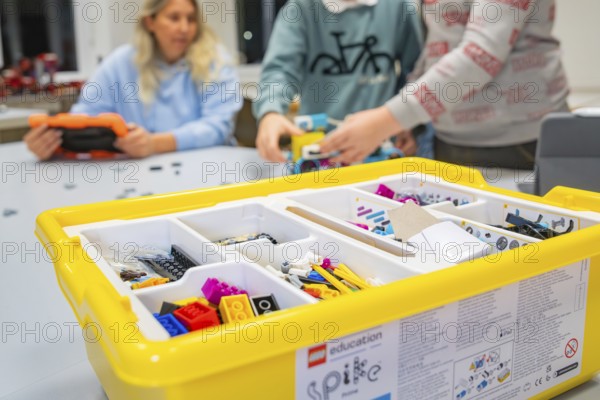 Children playing with a yellow Lego set on a table, Jugend Forschungszentrum Nagold, Calw district,