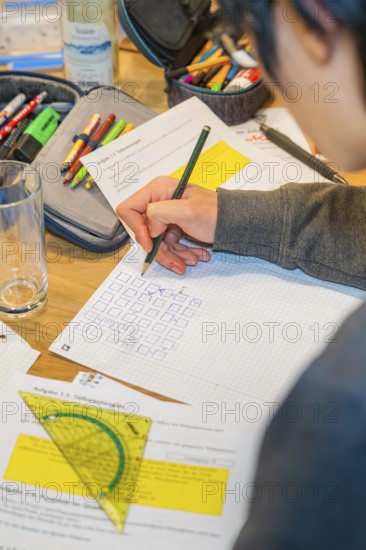 Person writes notes on paper using multiple tools, Jugend Forschungszentrum Nagold, Calw district,