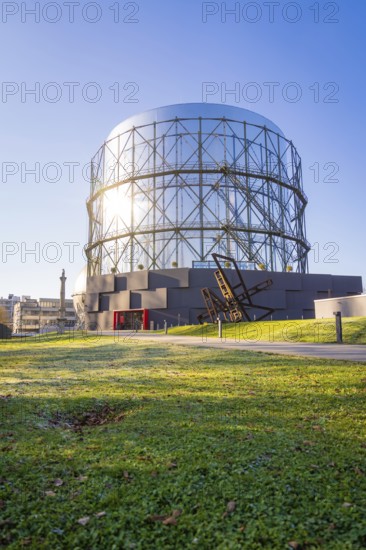 Round steel structure with green lawn underneath under blue sky, Amazonia exhibition, Gasometer,