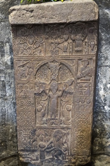 Detailed ancient relief with figures and ornaments carved in stone, Crossstone, Sevanavank